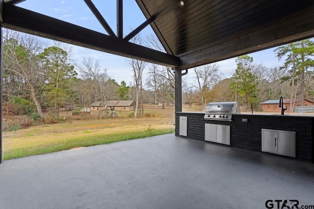 view of patio / terrace featuring area for grilling, sink, and grilling area