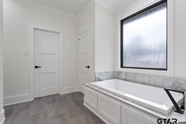 bathroom with a bathing tub and ornamental molding