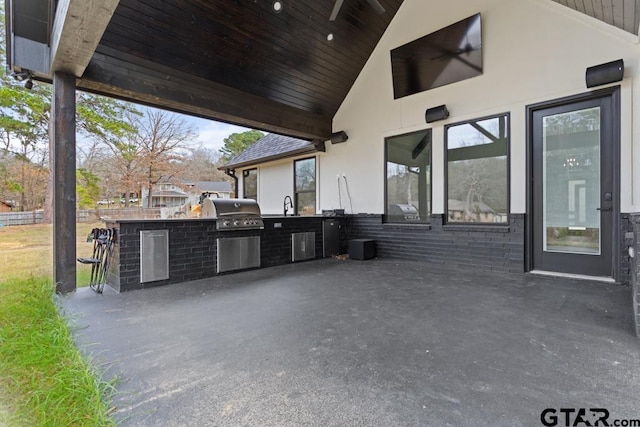 view of patio with sink, area for grilling, and exterior kitchen