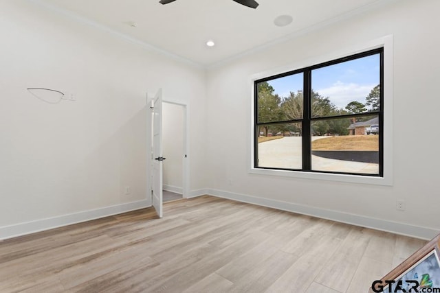 empty room with light hardwood / wood-style flooring, ceiling fan, and ornamental molding