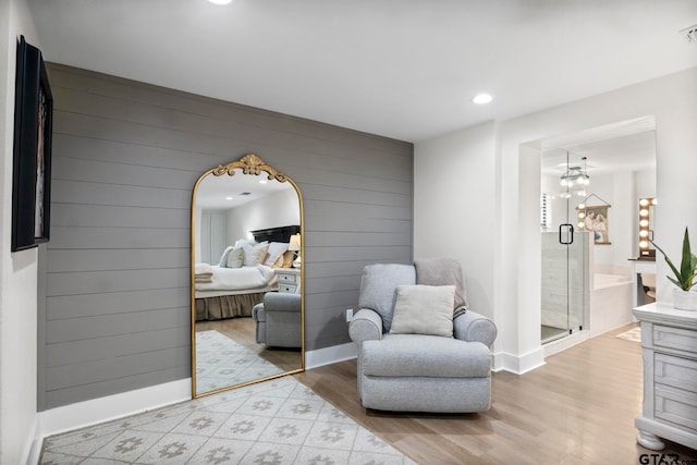 living area featuring wooden walls and light hardwood / wood-style flooring