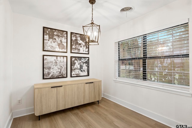 sitting room featuring an inviting chandelier and light hardwood / wood-style flooring