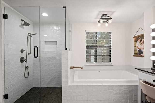 bathroom with vanity and independent shower and bath