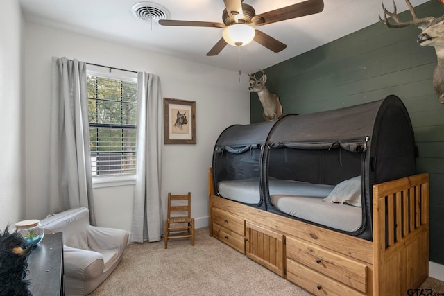 bedroom featuring light colored carpet and ceiling fan