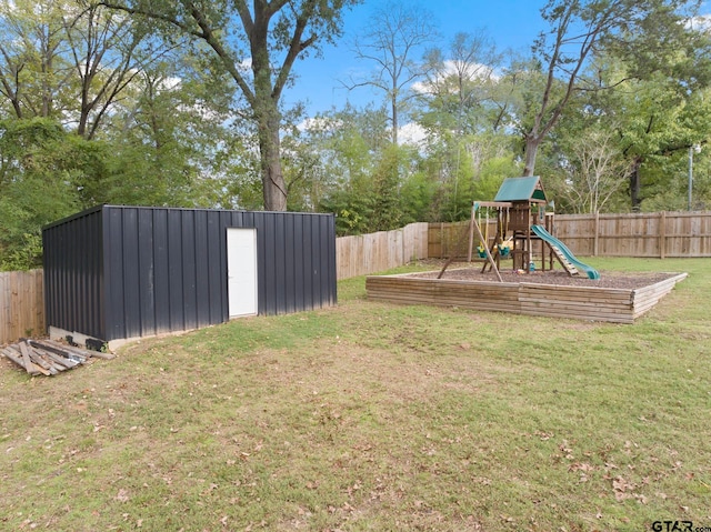 view of yard with an outdoor structure and a playground