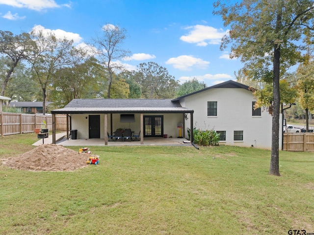 back of house with a yard, french doors, and a patio