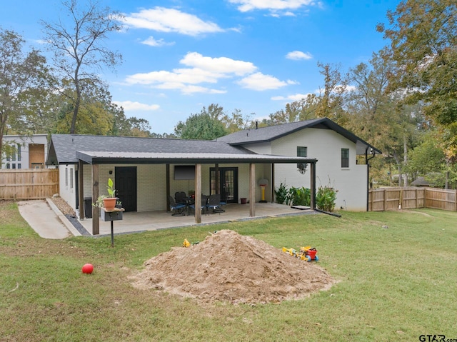 back of house featuring a patio and a lawn