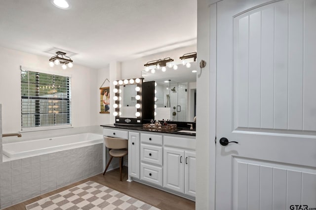 bathroom with shower with separate bathtub, vanity, and hardwood / wood-style flooring