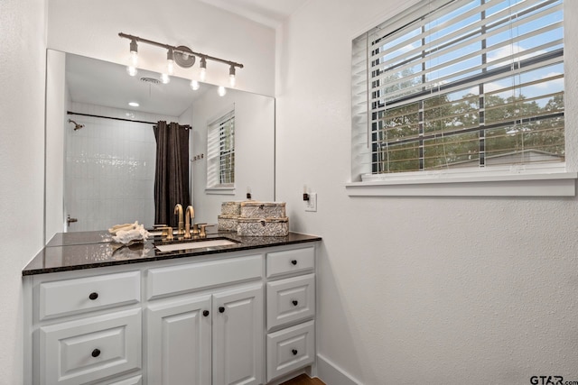 bathroom featuring a shower with curtain and vanity