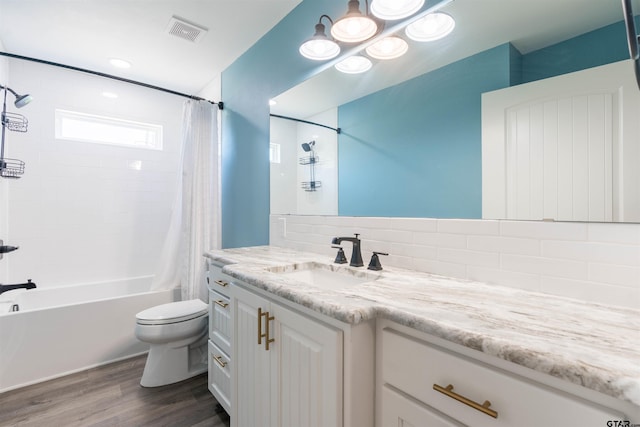 full bathroom with wood-type flooring, vanity, decorative backsplash, toilet, and shower / tub combo with curtain