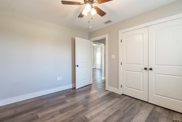 unfurnished bedroom featuring hardwood / wood-style flooring, ceiling fan, and a closet