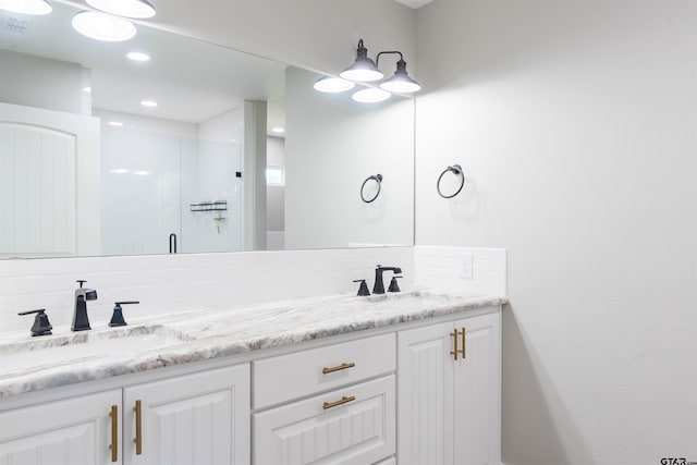 bathroom featuring walk in shower, vanity, and decorative backsplash