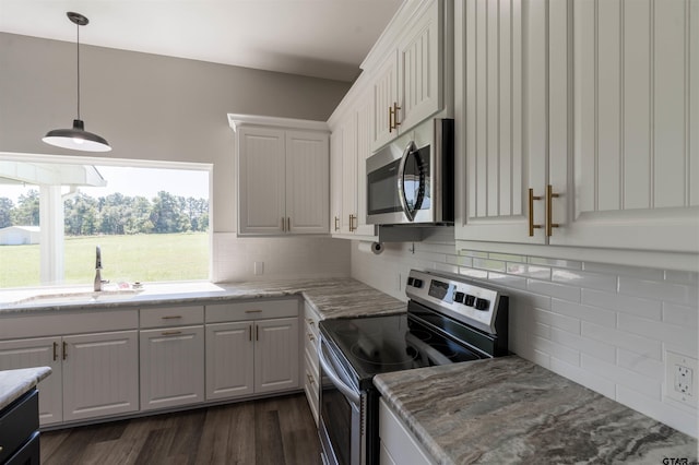 kitchen with dark wood-type flooring, white cabinetry, and stainless steel appliances