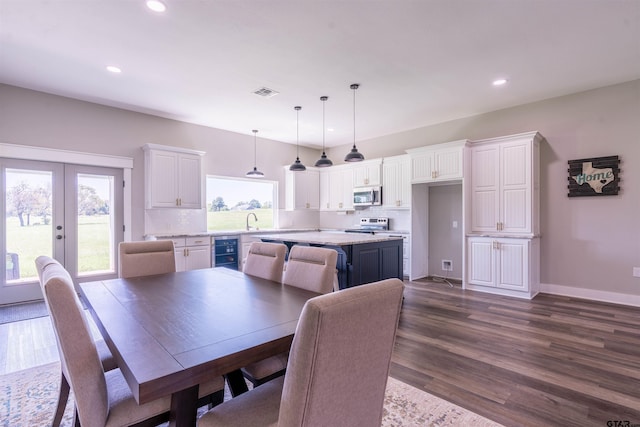 dining space with beverage cooler, french doors, and dark hardwood / wood-style floors