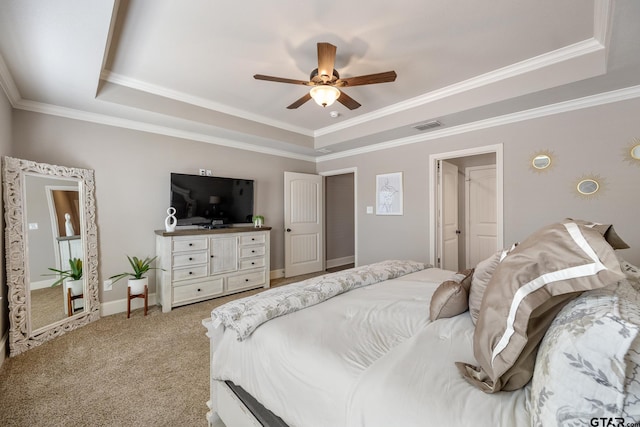 bedroom featuring visible vents, a raised ceiling, carpet floors, and crown molding