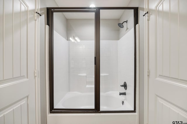 full bathroom with bath / shower combo with glass door