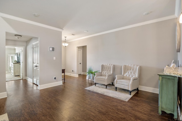 sitting room featuring crown molding, baseboards, and wood finished floors