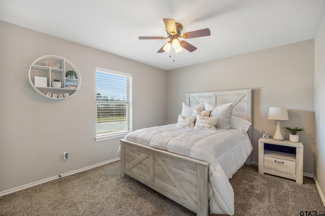 carpeted bedroom featuring baseboards and ceiling fan