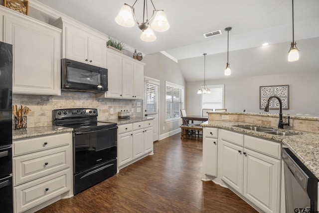 kitchen with a chandelier, vaulted ceiling, decorative backsplash, black appliances, and a sink