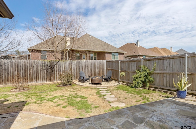 view of yard featuring an outdoor fire pit and a fenced backyard