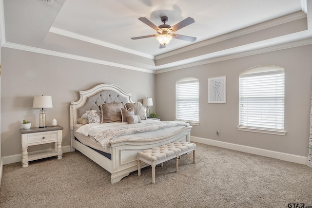 bedroom featuring a tray ceiling, light colored carpet, baseboards, and ornamental molding