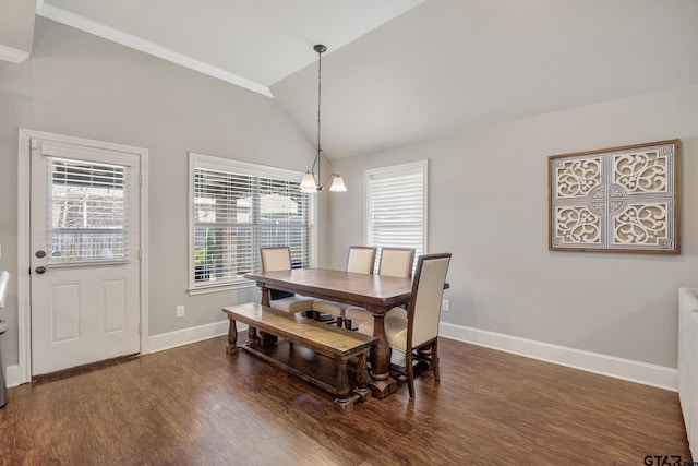 dining space with dark wood finished floors, baseboards, and vaulted ceiling