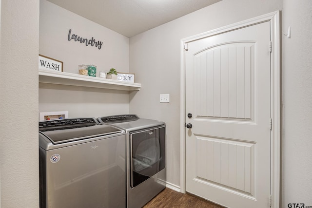 laundry room with dark wood finished floors, laundry area, and washer and clothes dryer