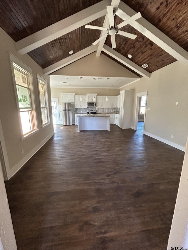 unfurnished living room with beamed ceiling, dark hardwood / wood-style floors, ceiling fan, and wooden ceiling