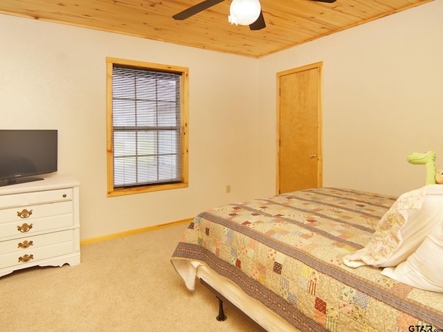 bedroom featuring ceiling fan, wooden ceiling, baseboards, and carpet floors