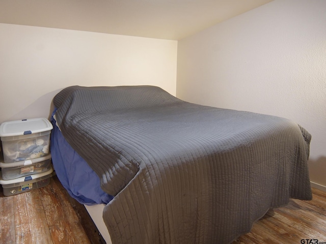 bedroom with wood finished floors