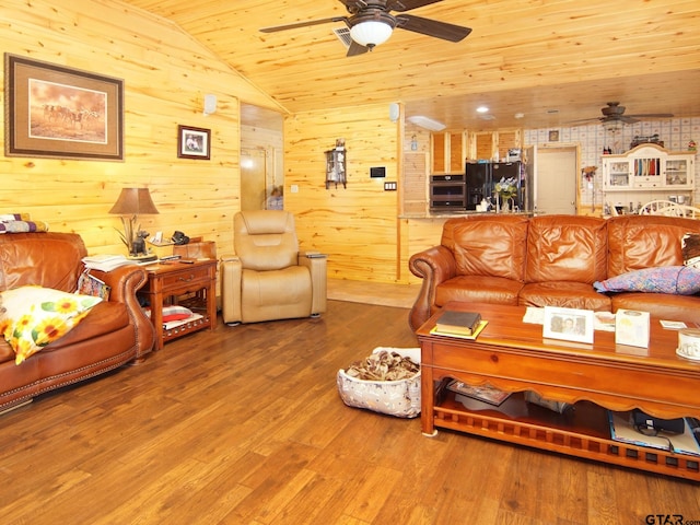 living area with visible vents, wood finished floors, wooden ceiling, ceiling fan, and vaulted ceiling