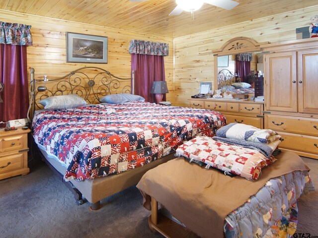 bedroom with carpet, wood ceiling, wood walls, and a ceiling fan