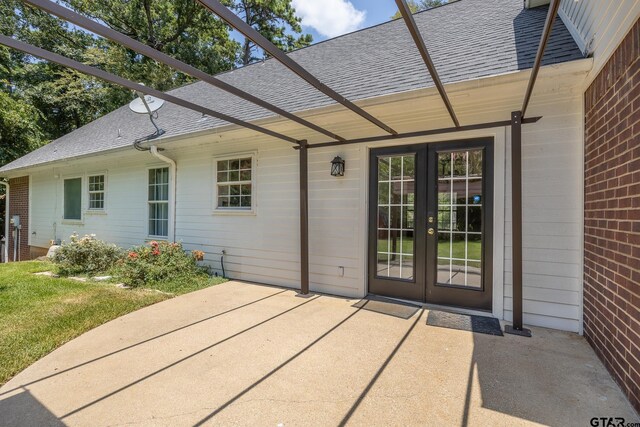 entrance to property with french doors and a patio