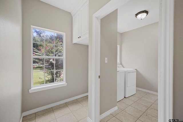 washroom with washer and dryer, cabinets, and light tile patterned floors