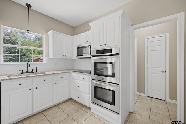 kitchen featuring white cabinets, light stone countertops, sink, and appliances with stainless steel finishes