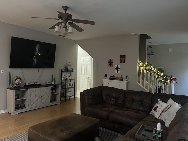 living room featuring hardwood / wood-style floors and ceiling fan