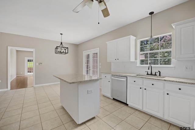 kitchen featuring stainless steel dishwasher, sink, pendant lighting, white cabinets, and a kitchen island