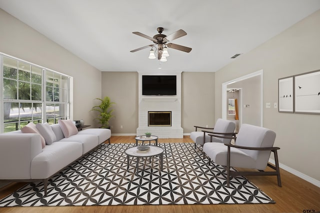 living room featuring a fireplace, ceiling fan, and hardwood / wood-style floors