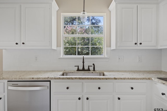 kitchen featuring sink, hanging light fixtures, stainless steel dishwasher, backsplash, and white cabinets