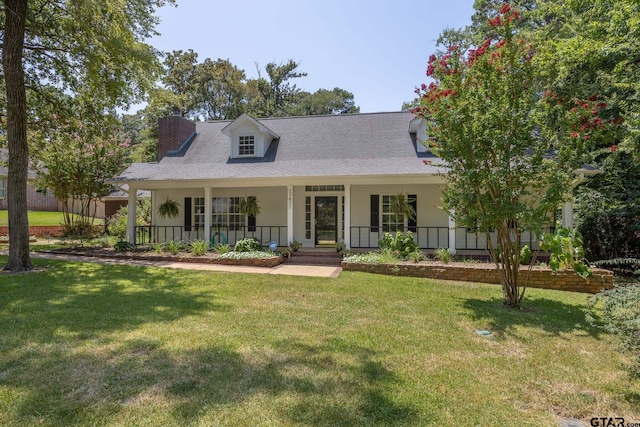 cape cod house with covered porch and a front lawn