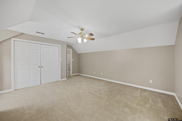 bonus room featuring ceiling fan, light colored carpet, and vaulted ceiling