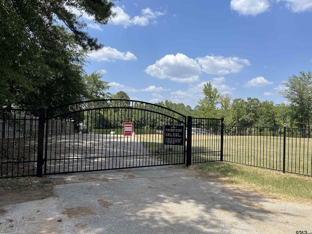 view of gate featuring fence