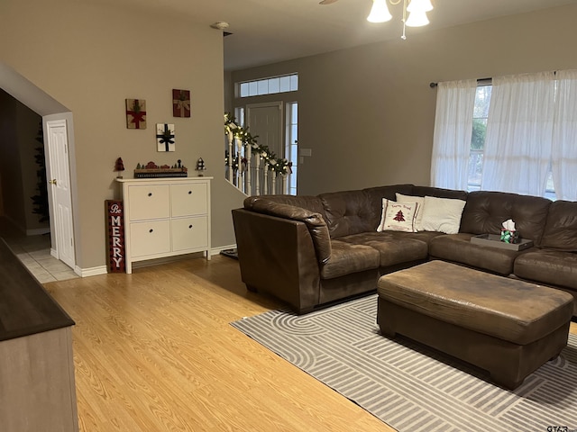 living room with light hardwood / wood-style flooring and ceiling fan