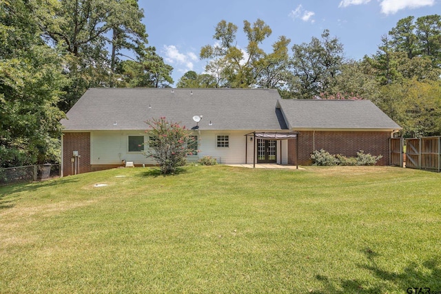 rear view of property featuring a lawn, a patio area, and a pergola