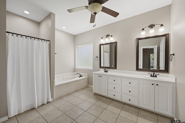 bathroom featuring tile patterned flooring, a healthy amount of sunlight, ceiling fan, and a tub