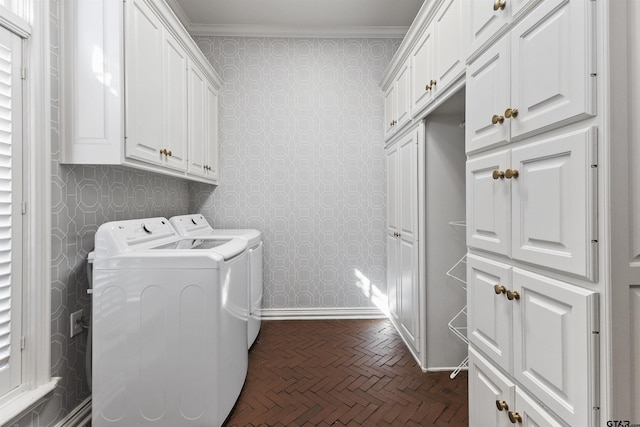 laundry room featuring cabinets, ornamental molding, and washer and clothes dryer