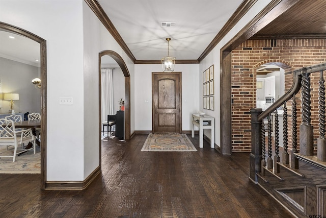 entryway featuring ornamental molding, brick wall, and dark hardwood / wood-style flooring