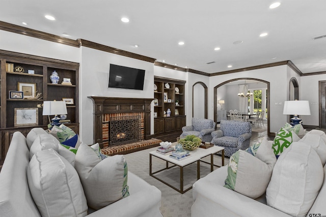 living room with crown molding and a fireplace