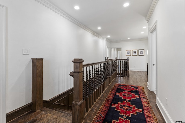 hallway with dark wood-type flooring and ornamental molding