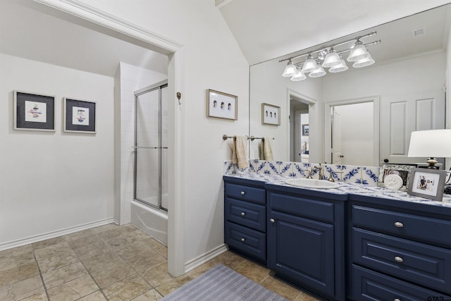 bathroom with vanity and bath / shower combo with glass door